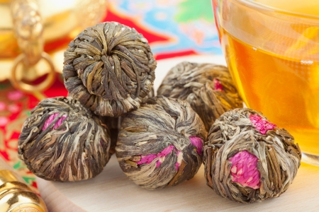 Chinese green tea balls with flowers, tea cup の写真素材