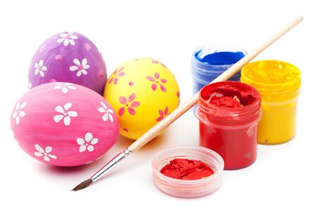 easter eggs with paints and paintbrush on whiteの写真素材
