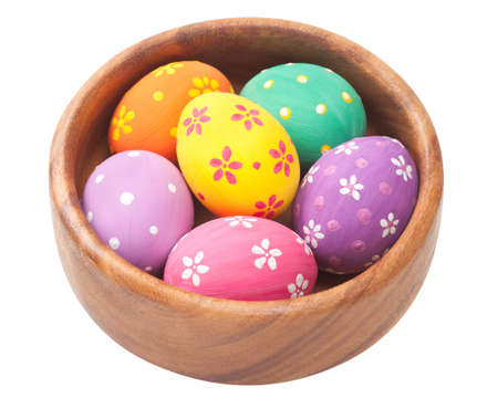 easter eggs in wooden bowl, isolatedの写真素材