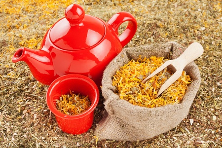 bag with healing herbs and red tea kettle, herbal medicine の写真素材