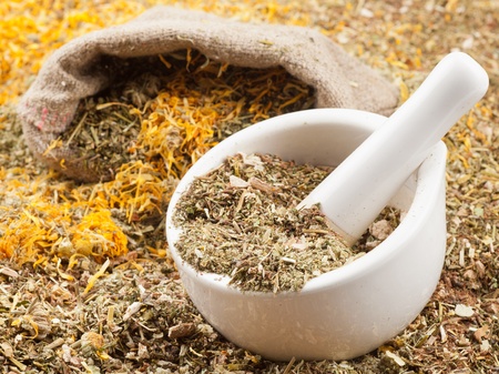 mortar, pestle and bag of healing herbs, herbal medicineの写真素材