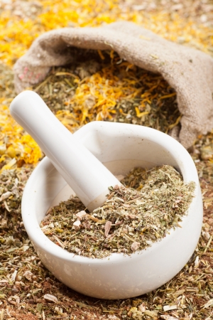 mortar, pestle and sack of healing herbs, herbal medicine の写真素材