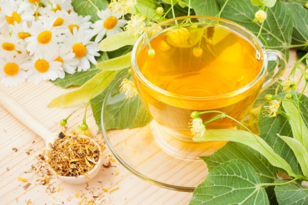 linden and chamomile flowers and cup of healthy tea, herbal medicineの写真素材