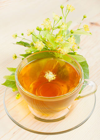 linden flowers and cup of healthy tea, herbal medicineの写真素材