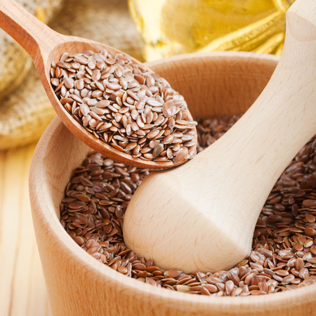  mortar with flax seeds, linseed in wooden spoonの写真素材