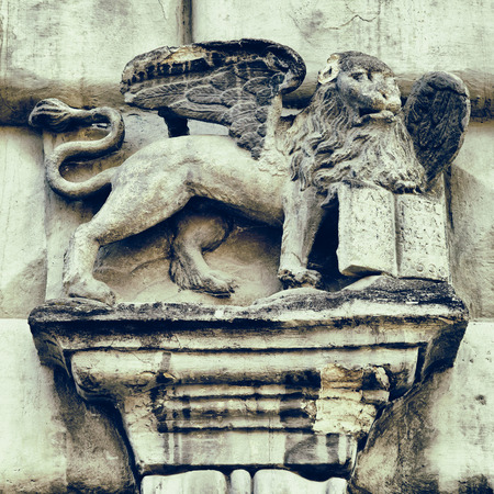 fragment of gothic facade decor in Lviv  - Griffon with bookの写真素材