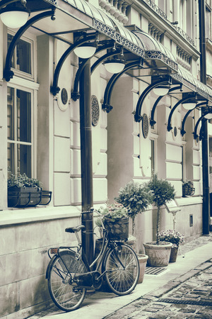 Vintage stylized photo of Old bicycle carrying flowers outdoorsの写真素材