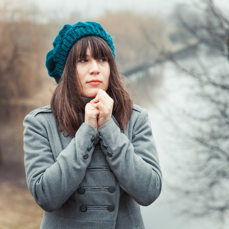 young pretty girl in cold weather in park outdoors, vintage portraitの写真素材