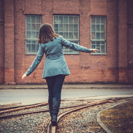 girl walking on the railwayの写真素材