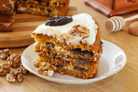 piece of honey cake with plum and walnut on kitchen tableの写真素材