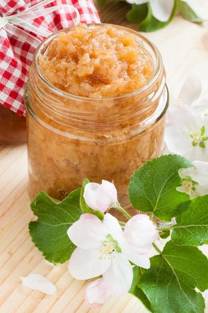 apple puree in glass jar on kitchen tableの写真素材
