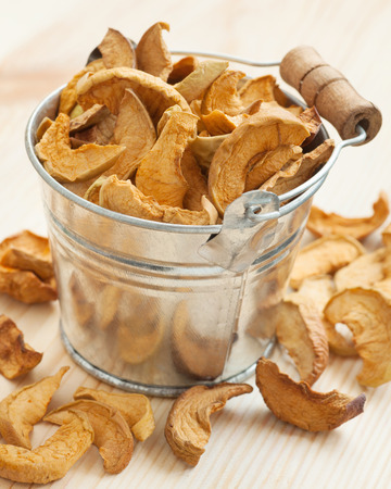dried apple slices in bucket on tableの写真素材