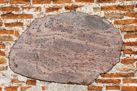 ancient building wall from red brick and stone の写真素材