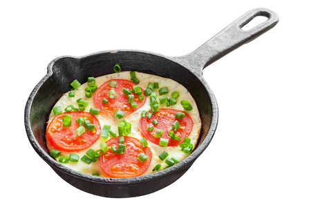 frying pan with scrambled eggs and tomatoes isolatedの写真素材