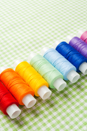 row of thread spools in rainbow colors
