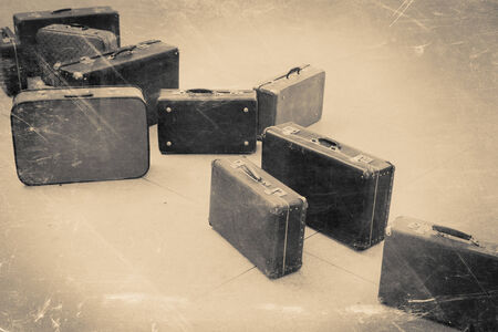 group of vintage suitcase on tiled floor, retro stylized in black and white color photoの写真素材