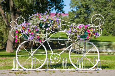 Vintage decorative bicycle carrying flowers outdoorsの写真素材
