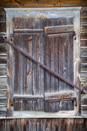 closed rustic window of old wooden houseの写真素材