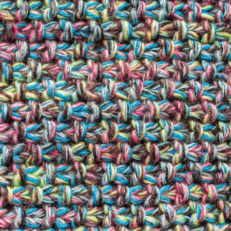 Multicolor knitted background from woolen yarns closeup