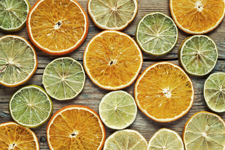 Dried orange and lemon slices on wooden table. Top view.の写真素材
