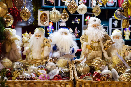 MOSCOW, RUSSIA - DECEMBER 24, 2014: Santa Claus dolls and glass balls. Christmas decoration selling during Christmas market  in the city of Moscow. Russia.のeditorial素材