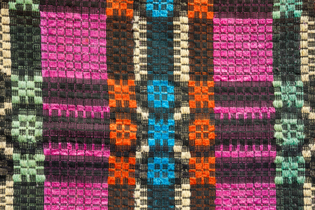 Texture of traditional colorful rug textile. Ethnic rustic carpet or cover design.の写真素材