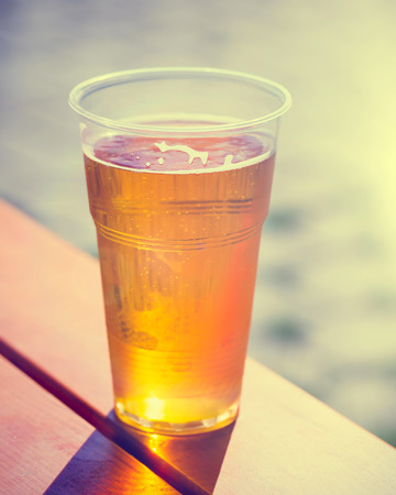 Retro styled photo of beer cup on tableの写真素材