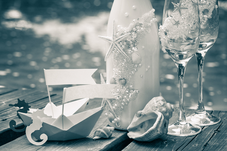 Wedding wine bottle, wineglasses and decoration in marine style.の写真素材