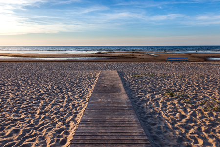 Wooden footpath to the sea at sunset.の写真素材