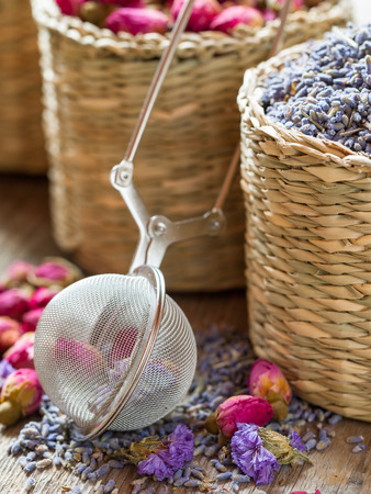 Lavender, roses Herbal tea in basket and tea strainer. Selective focus.の写真素材