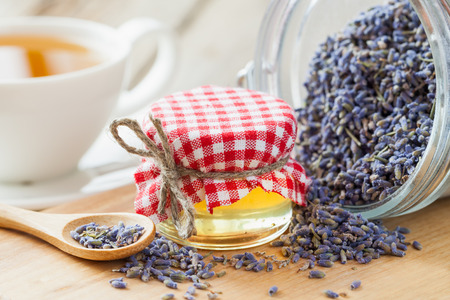 Jar of honey, dry healthy lavender tea and tea cup on background. Selective focus.の写真素材