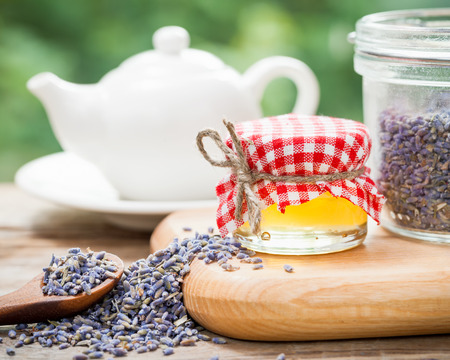 Jar of honey, lavender tea and teapot on background. Selective focus.の写真素材