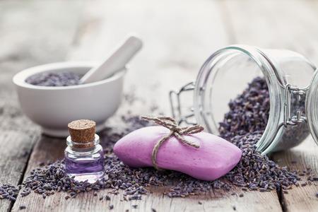 Bars of homemade soaps, dry lavender flowers and essential oil. Selective focus.の写真素材