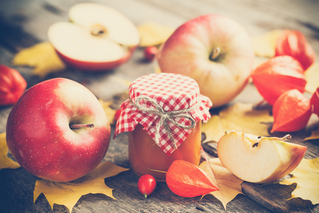 Apple jam in jar and apple fruits. Autumn still life. Selective focus.の写真素材