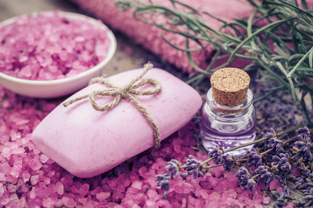 Bar of homemade soaps, sea salt, essential oil and dry lavender flowers. Selective focus.の写真素材