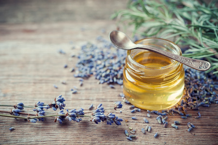 Jar of honey and dry  lavender flowers for tea. Selective focus.の写真素材