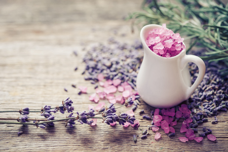 Jug of sea salt  and dry lavender flowers. Selective focus.の写真素材