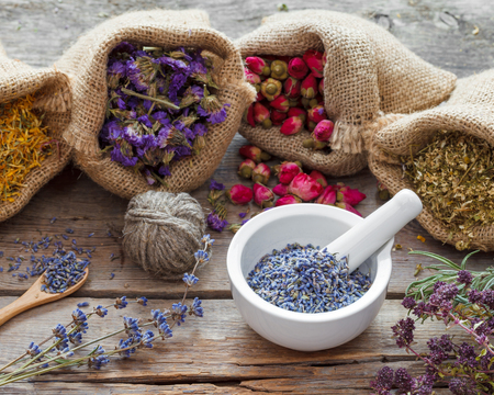 Healing herbs in hessian bags and mortar with dry lavender, herbal medicine.の写真素材