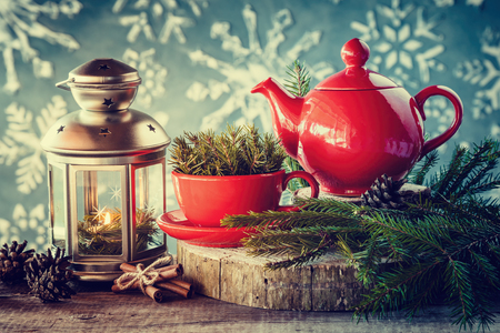 Christmas decoration: lantern with candle, tea kettle and cup with spruce twigs.の写真素材