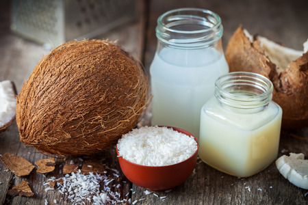 Coconut oil and milk, grounded coconut flakes and fresh coco nut.の写真素材