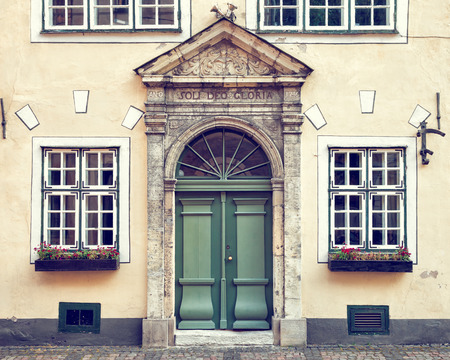 Vintage door on  a medieval building facade in old Riga city, Latviaの写真素材