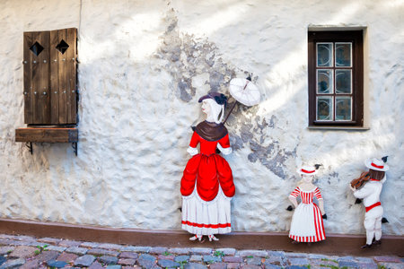 Riga, Latvia - 24-August-2015: Decorative figures of lady with umbrella and two childrens on old medieval narrow street in Riga, Latvia.のeditorial素材