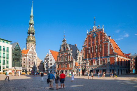 Riga, Latvia - 24-August-2015: Town Hall Square - house of the Blackheads, sculpture of Saint Roland and Saint Peters Church in old city Riga, Latviaのeditorial素材