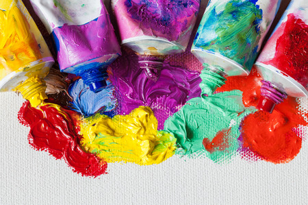 Tubes of oil paint and artist paintbrushes closeup on artistic canvasの写真素材