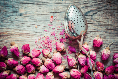 Dry rose buds tea and tea infuser. Top view.の写真素材