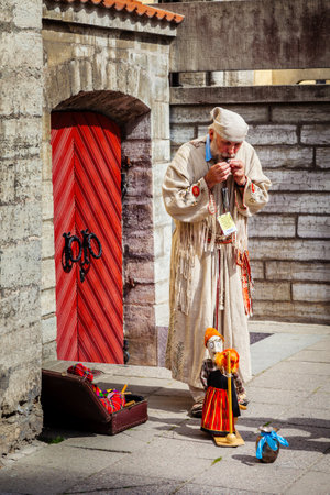 Tallinn, Estonia - June 2, 2016: Puppet master and string marionette doll in the Historical Center of Tallinn city. Tallinn, Estonia.のeditorial素材