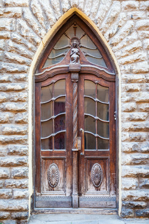 Vintage door on a old building facade in old Tallinn city, Estoniaのeditorial素材