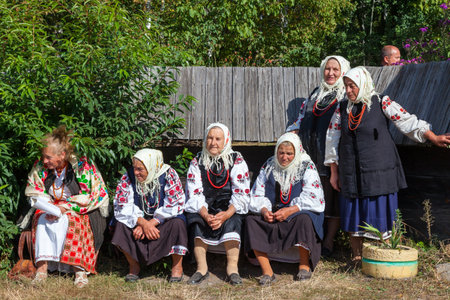 KIEV, UKRAINE - SEPTEMBER 18, 2016: Ukrainian senior women in Museum of Ukrainian Folk Architecture and Rural Life Pirogovo, on September 18, 2016. Kiev, Ukraine.のeditorial素材