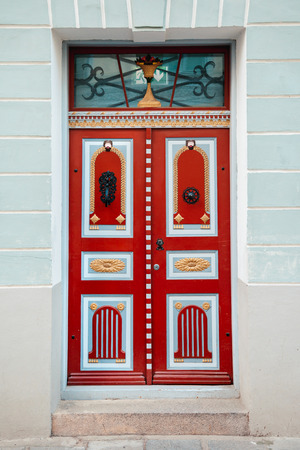 Red vintage door on a old building facade in old Tallinn city, Estoniaの写真素材