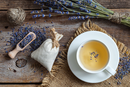 Bunch of lavender flowers, sachets filled with dried lavender and healthy tea. Top view. Flat lay.の写真素材
